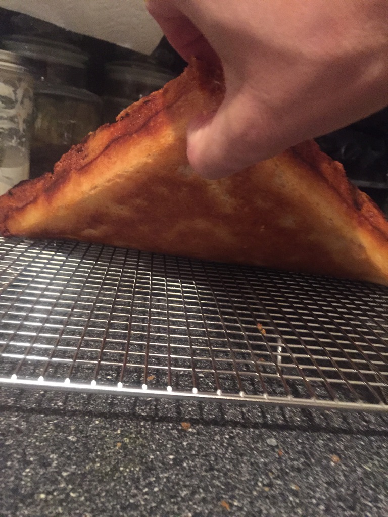 Crispy bottom crust on Detroit style pizza